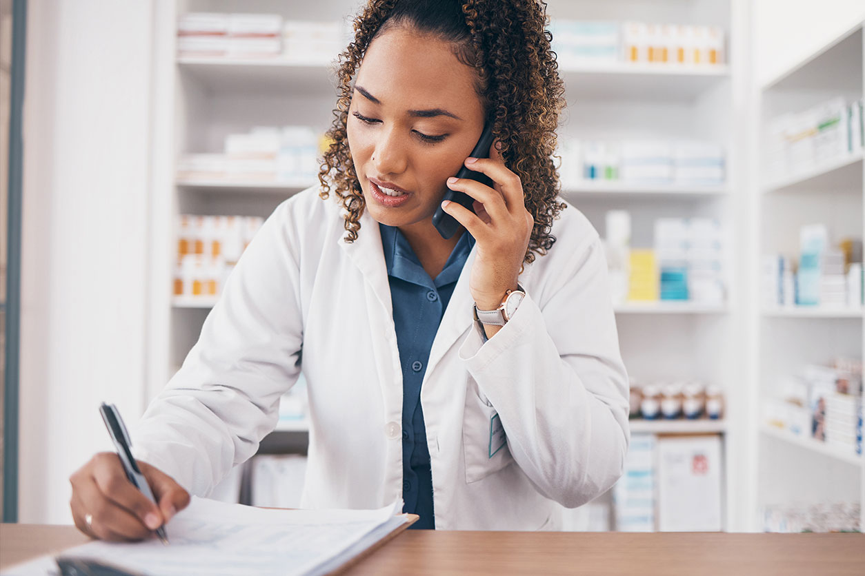 Stressed female pharmacist on the phone